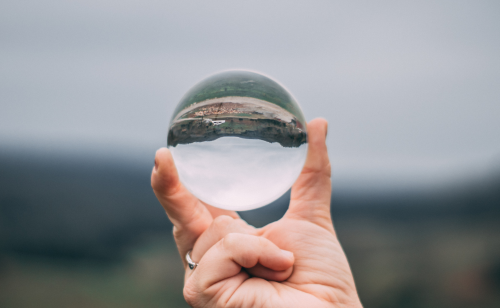 Shows mirrored reflection in a crystal ball