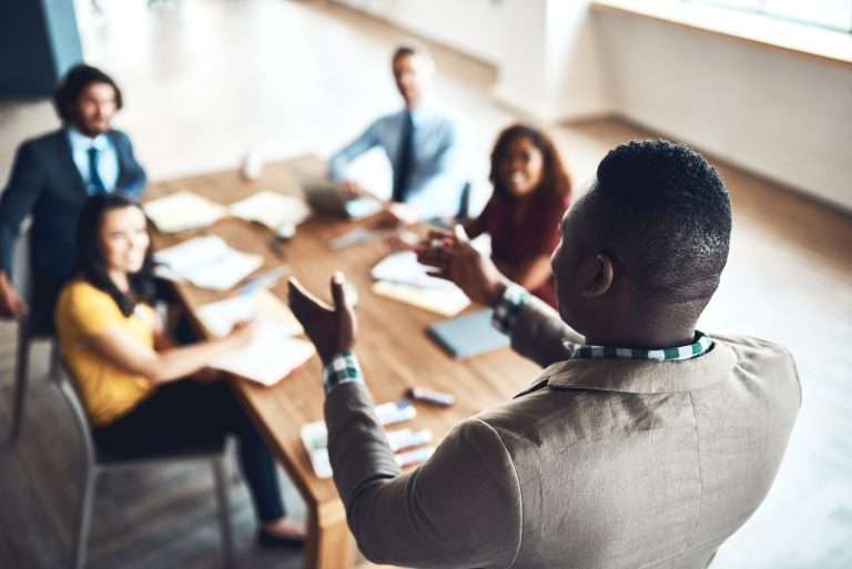 A man teaching working professionals