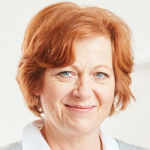 Headshot of a middle-aged woman with red hair