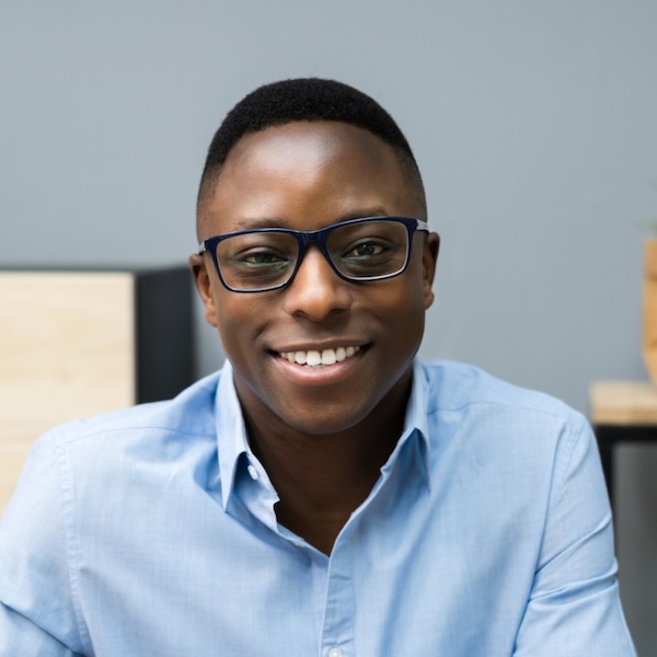 Professional headshot of an African American man with glassess