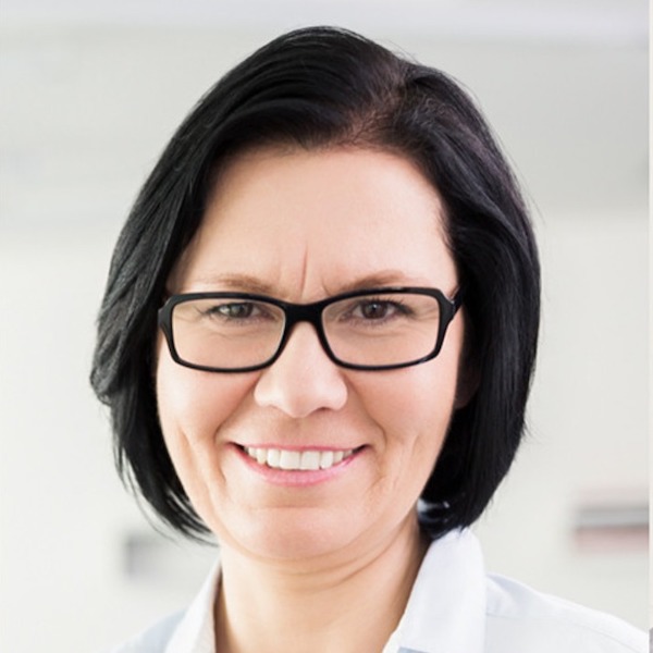 Headshot of a woman with a bob and glasses