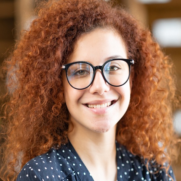 A woman with glasses and red curly hair