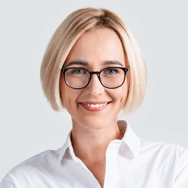 Headshot of a younger woman with short hair and glasses