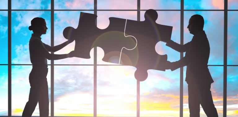 Outlines of a man and a woman sticking puzzle pieces together