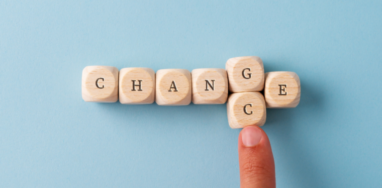 Blocks that spell out "change" with a finger pushing the G block out and replacing it with a C block to spell "chance."