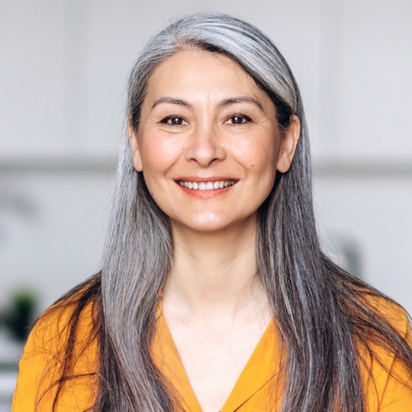 Professional headshot of a woman with long gray hair