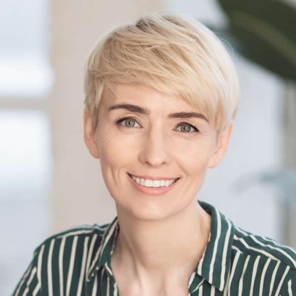 Professional headshot of a woman with short blonde hair