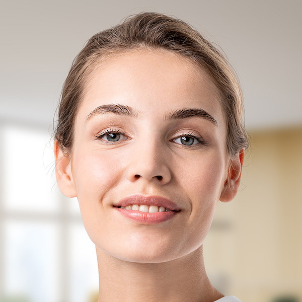 Professional headshot of a woman with her hair tied back