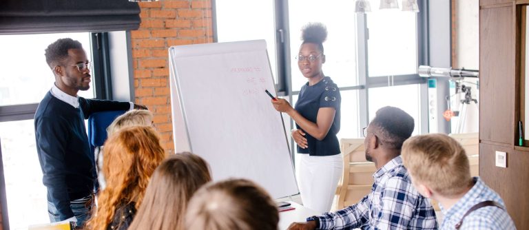 A woman and man providing training to professionals