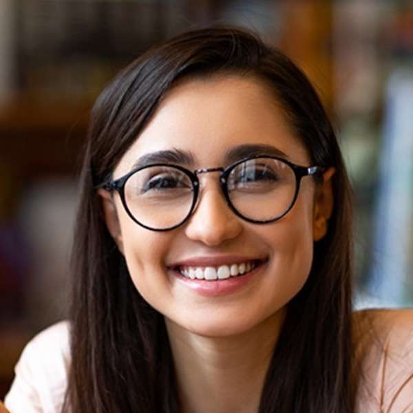 Headshot of a young woman wearing glasses
