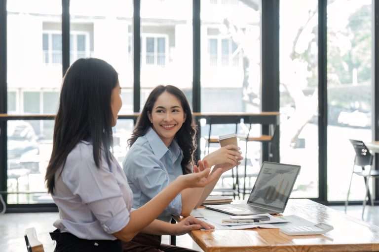 Two female coworkers creating a supportive work environment