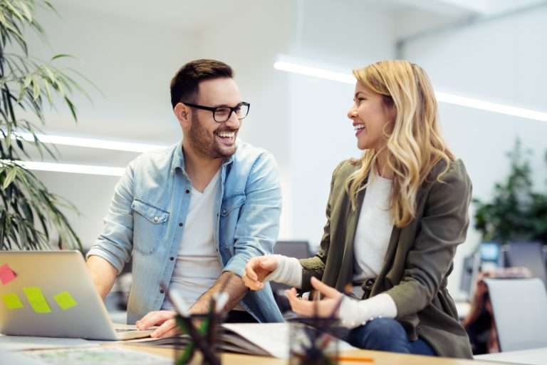Two coworkers actively listening and conversing with each other