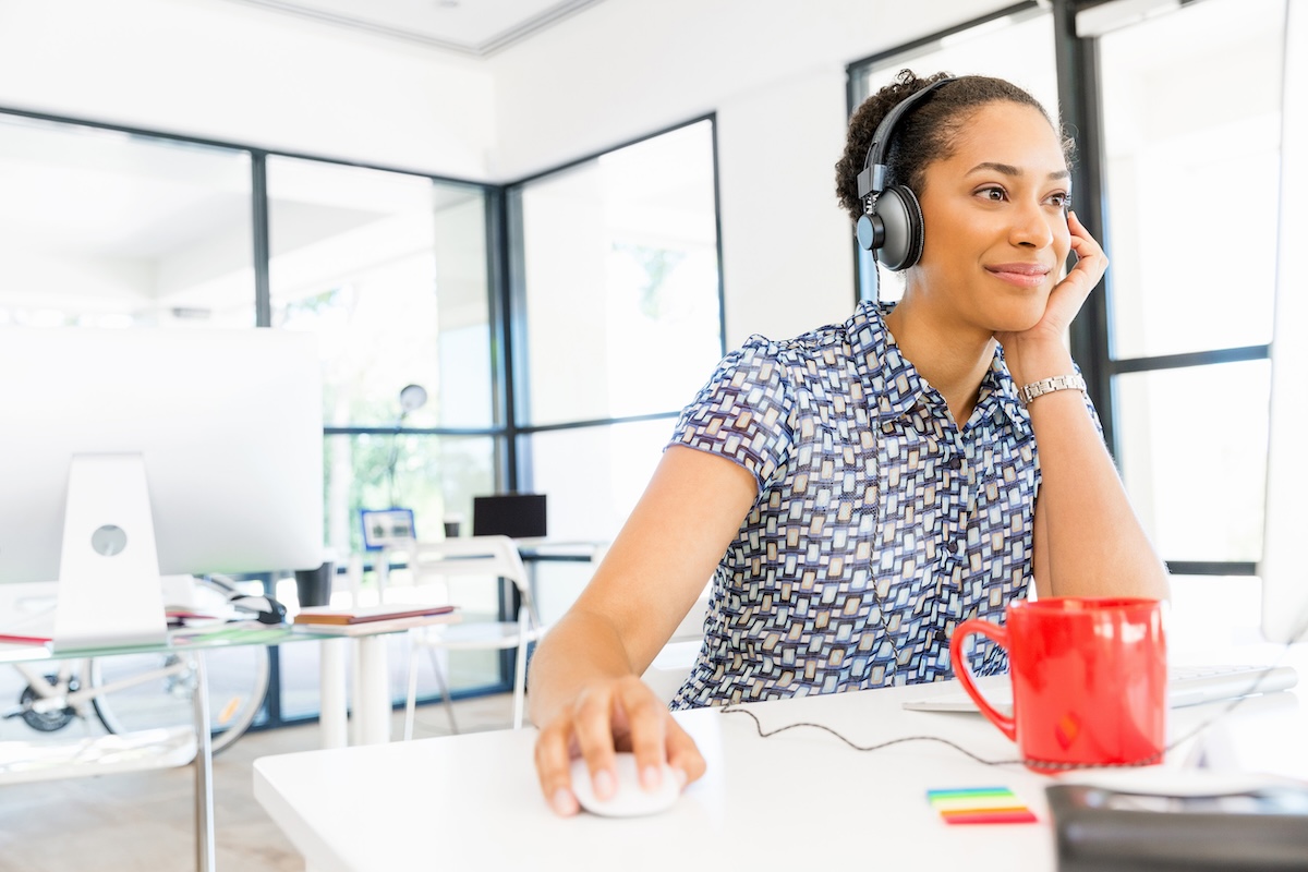 Woman watching a webinar at work