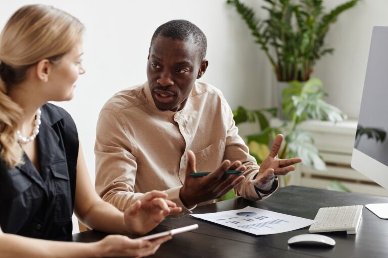 A male and female coworker talking to each other