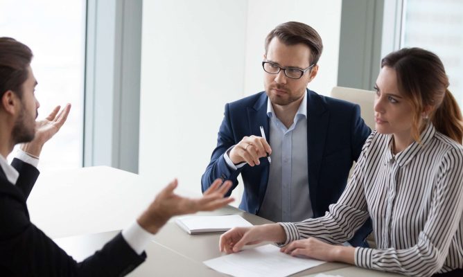 Coworkers working through conflict with effective conflict resolution strategies