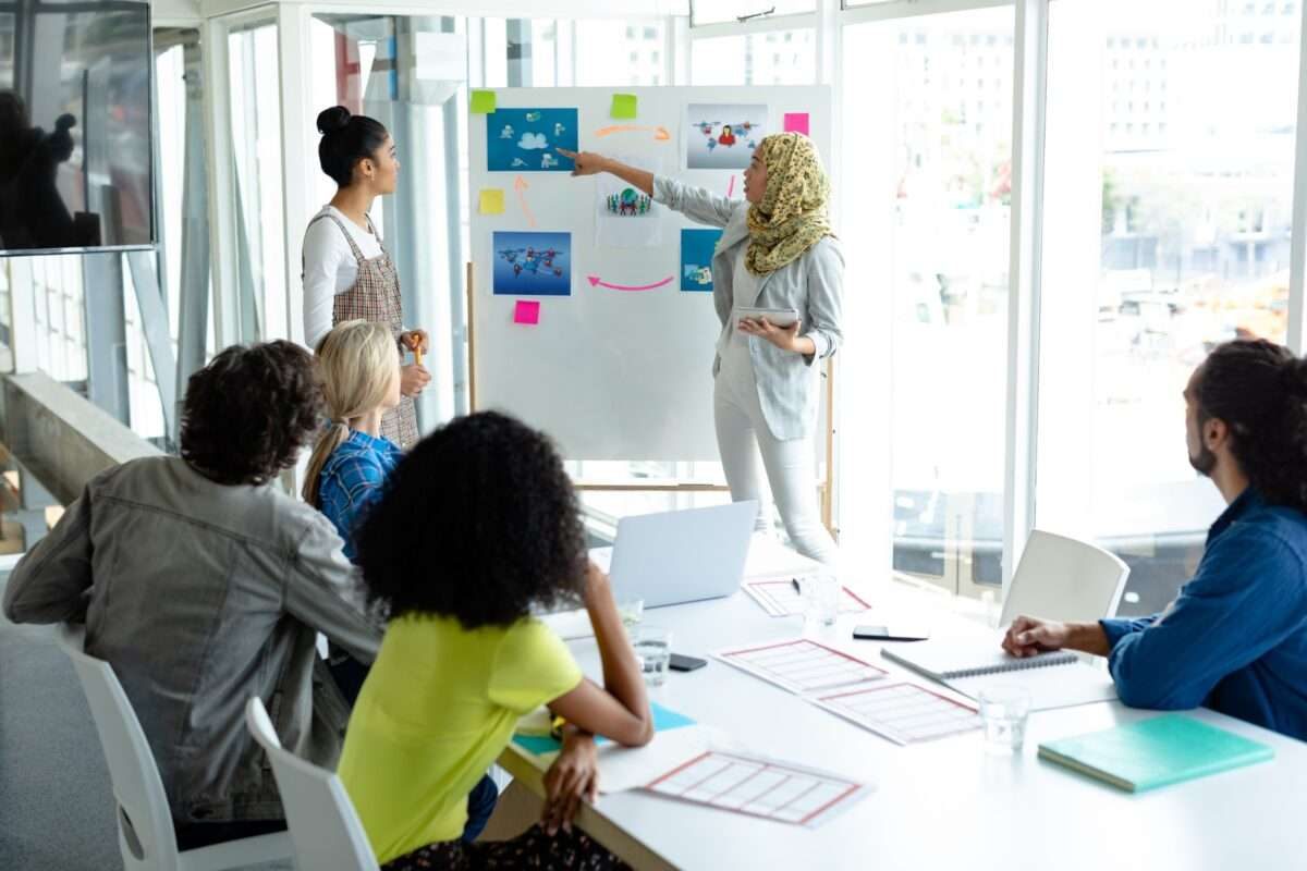 A woman presenting her plan to a few coworkers