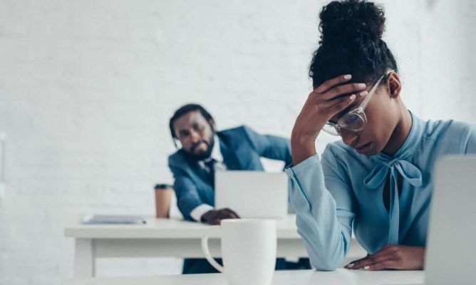 Stressed woman and concerned colleague