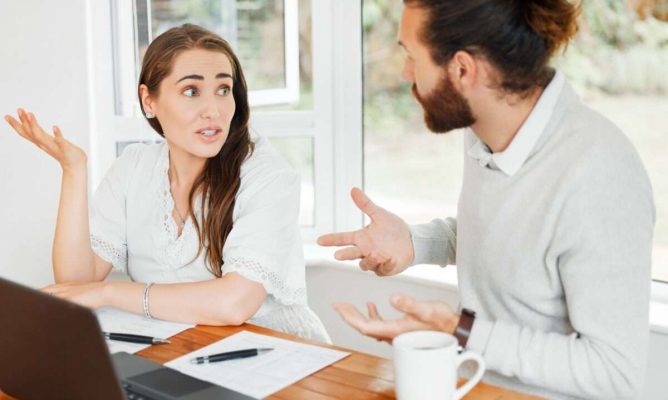 A woman and a man have a tense discussion