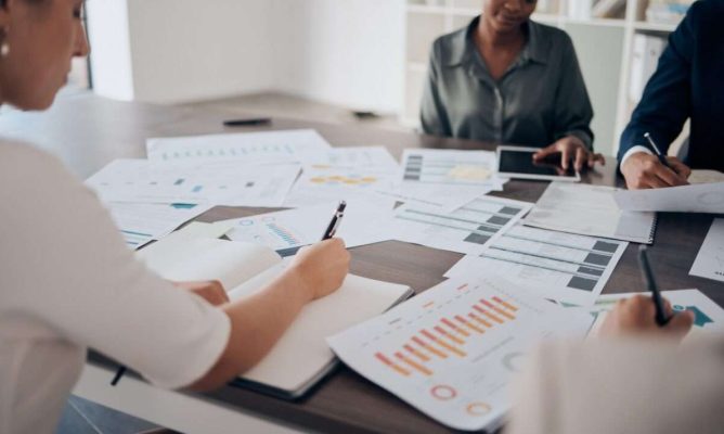 Two women and a man at a business planning meetings