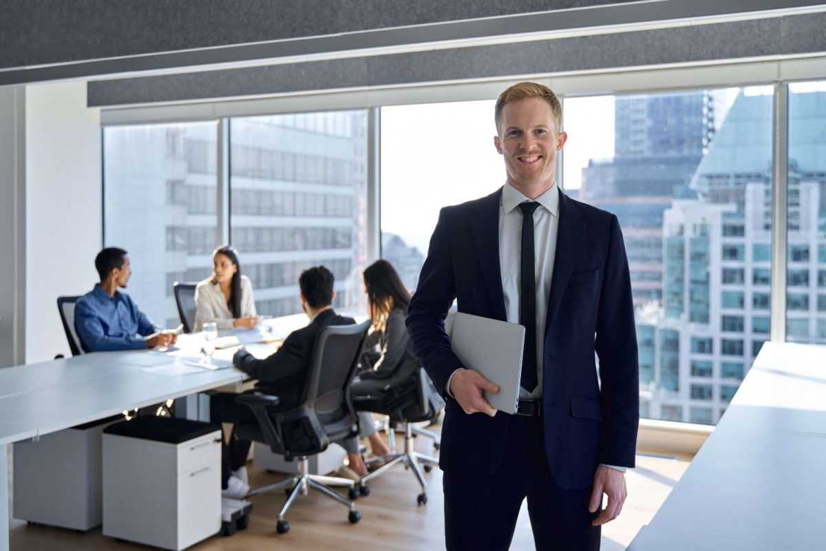 A supervisor standing in front of his team while they talk