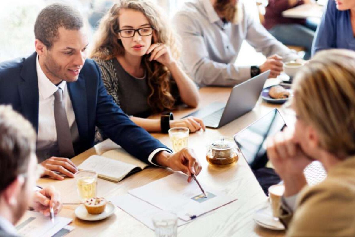 Coworkers in a team meeting discussing a project
