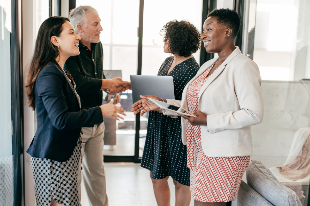 Coworkers greeting each other in the hall