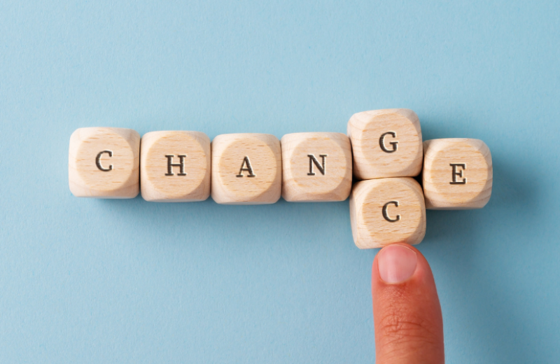 Blocks that spell out "change" with a finger pushing the G block out and replacing it with a C block to spell "chance."