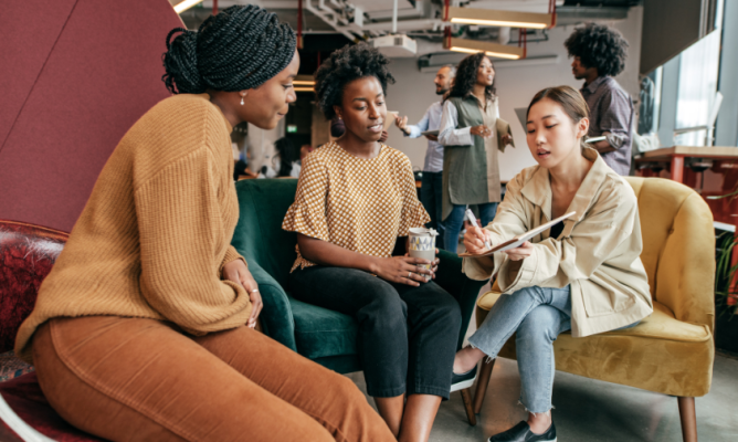 A diverse group of men and women in the workplace discussing