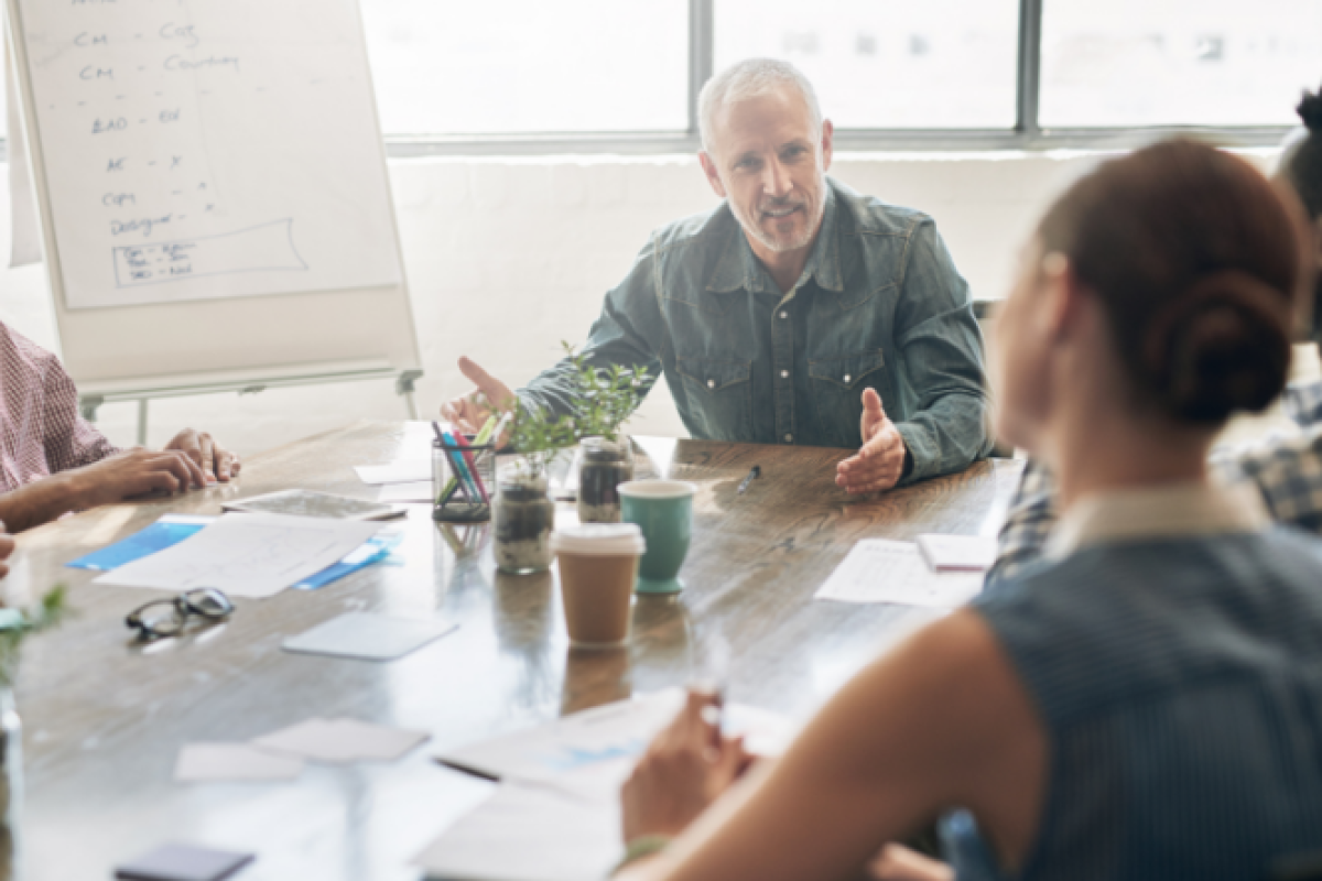 Team members discussing around a table