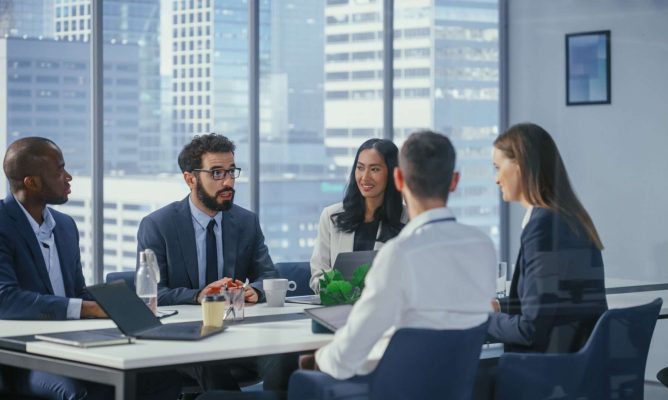 Coworkers using the power of influence in a meeting