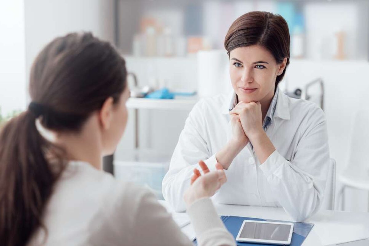 12 Barriers to Effective Listening & How to Overcome Them: A woman listening intently while a coworker is talking