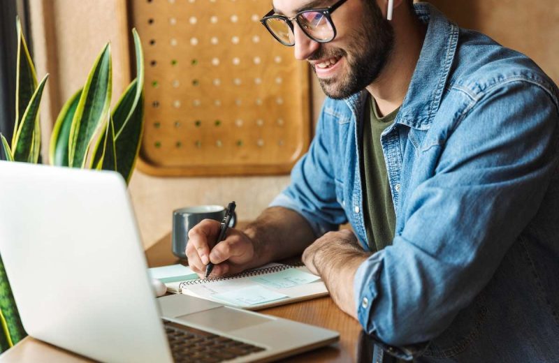 A man watching a webinar on his computer
