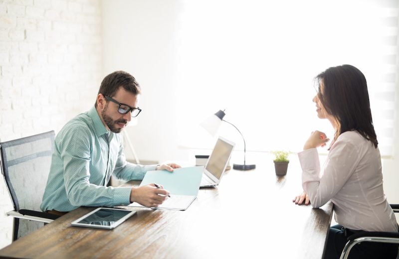 A woman asking for a raise at work