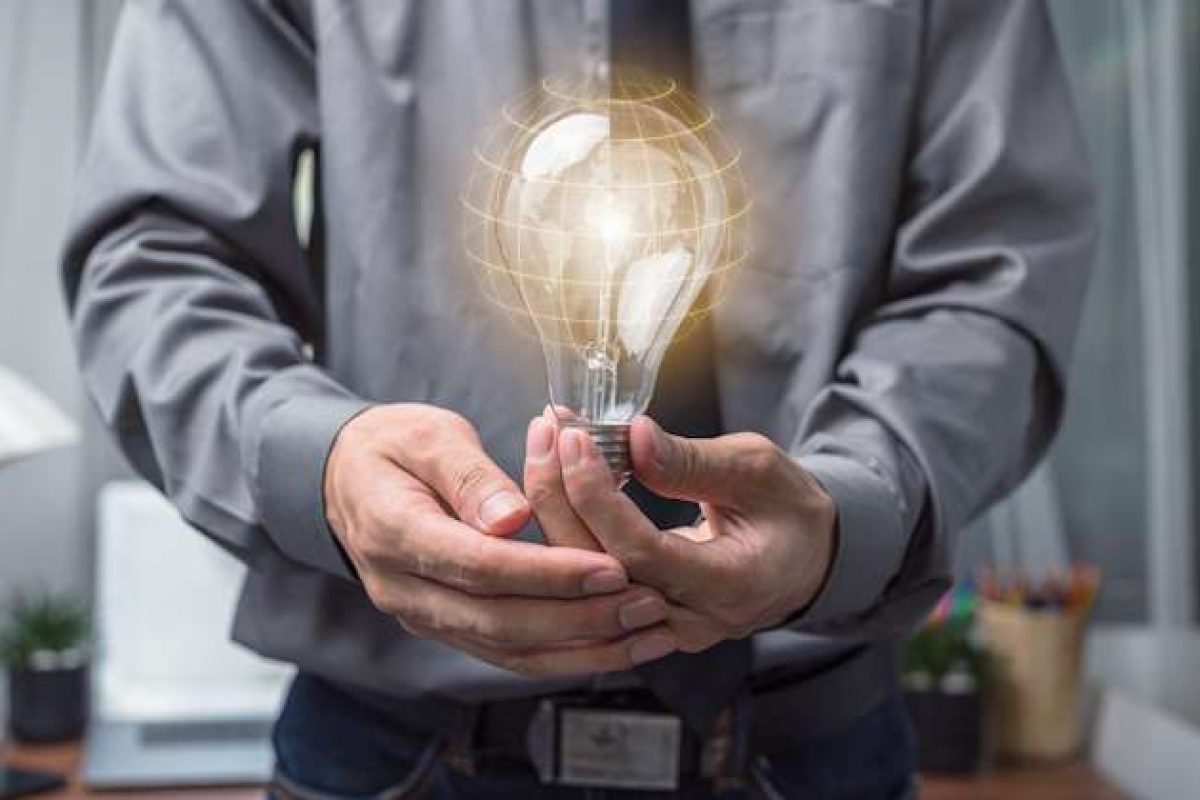 A man holding a light bulb