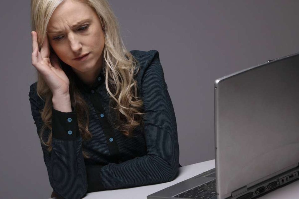 A woman stressed while working at her computer