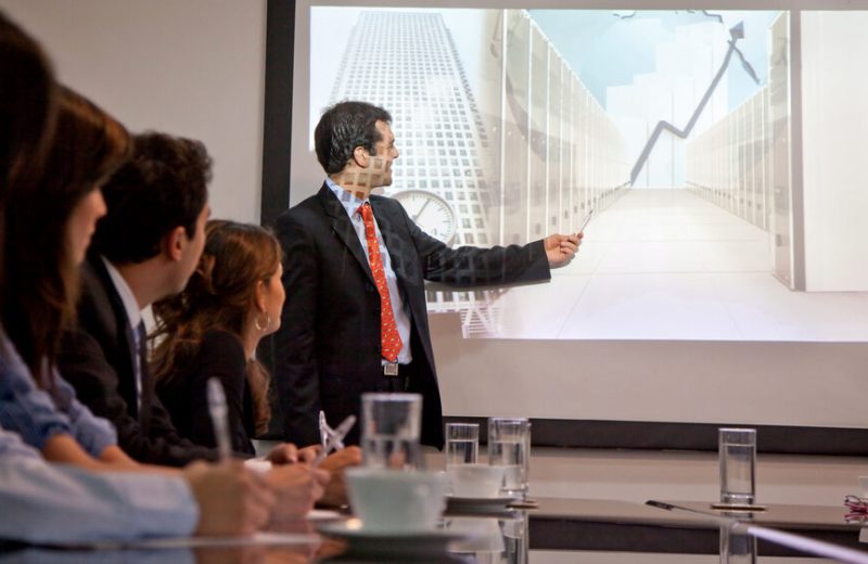 A man presenting a graph in a work meeting