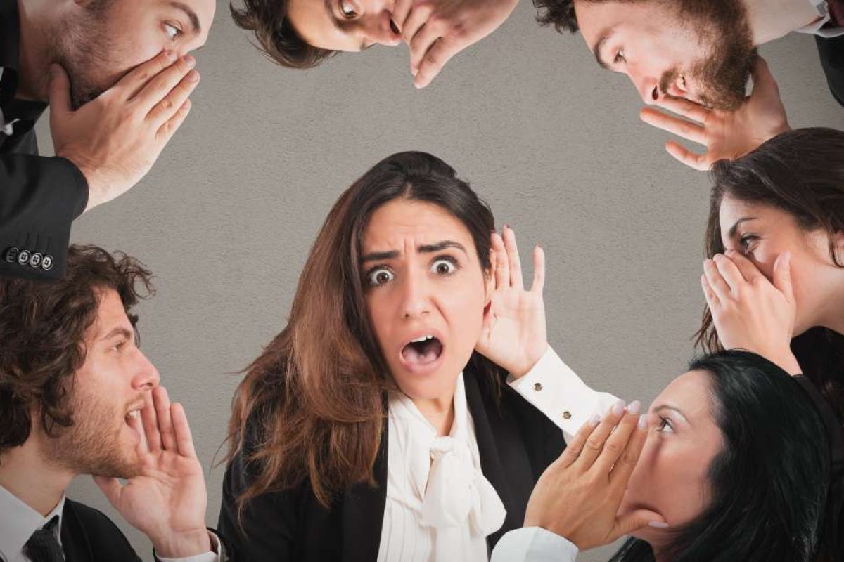 People in a circle whispering in each other's ears