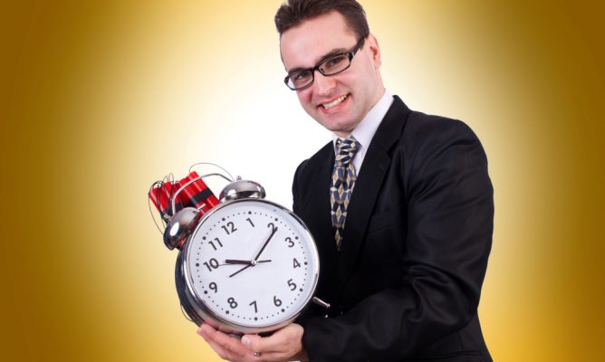 A man holding a large clock