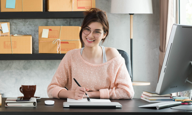 A woman sitting comfortably at her desk