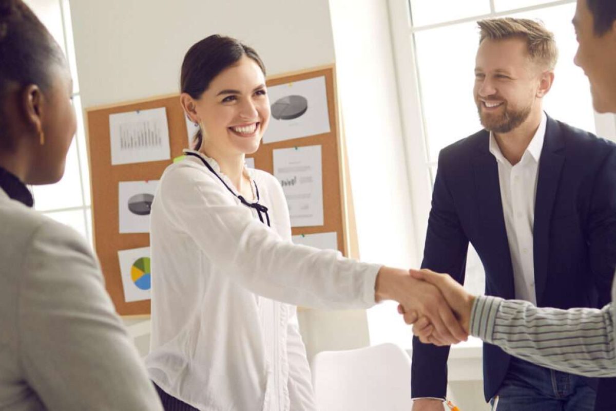 A woman shaking hands with a man