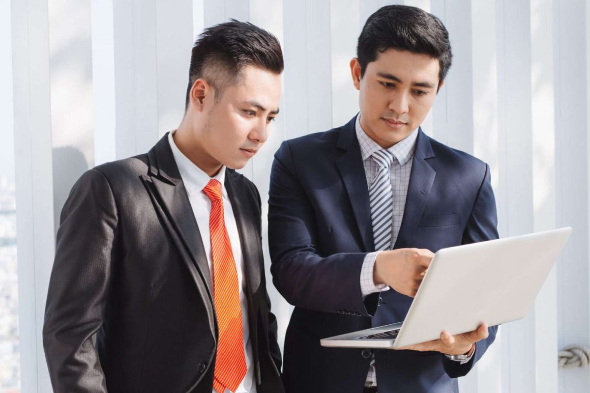 Two men looking at a computer