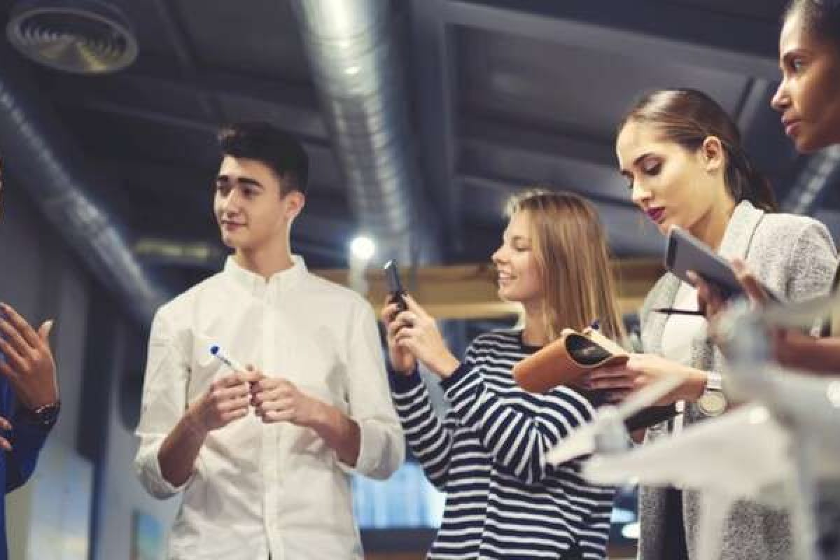 A group of coworkers talking in a circle
