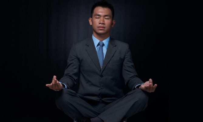 A man in a suit meditating
